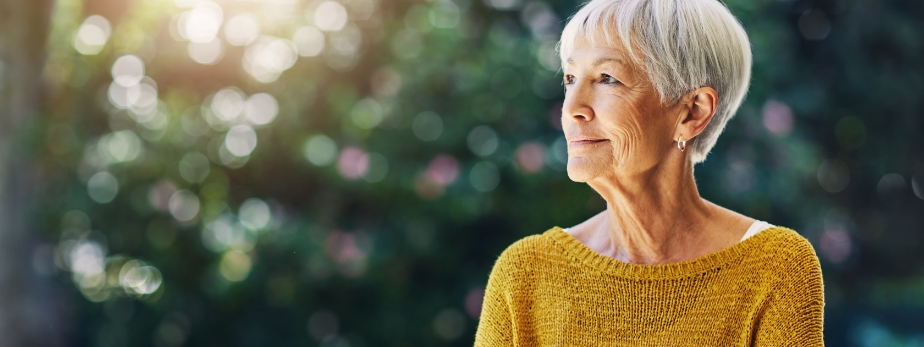 Confident senior woman looking thoughtful outdoors